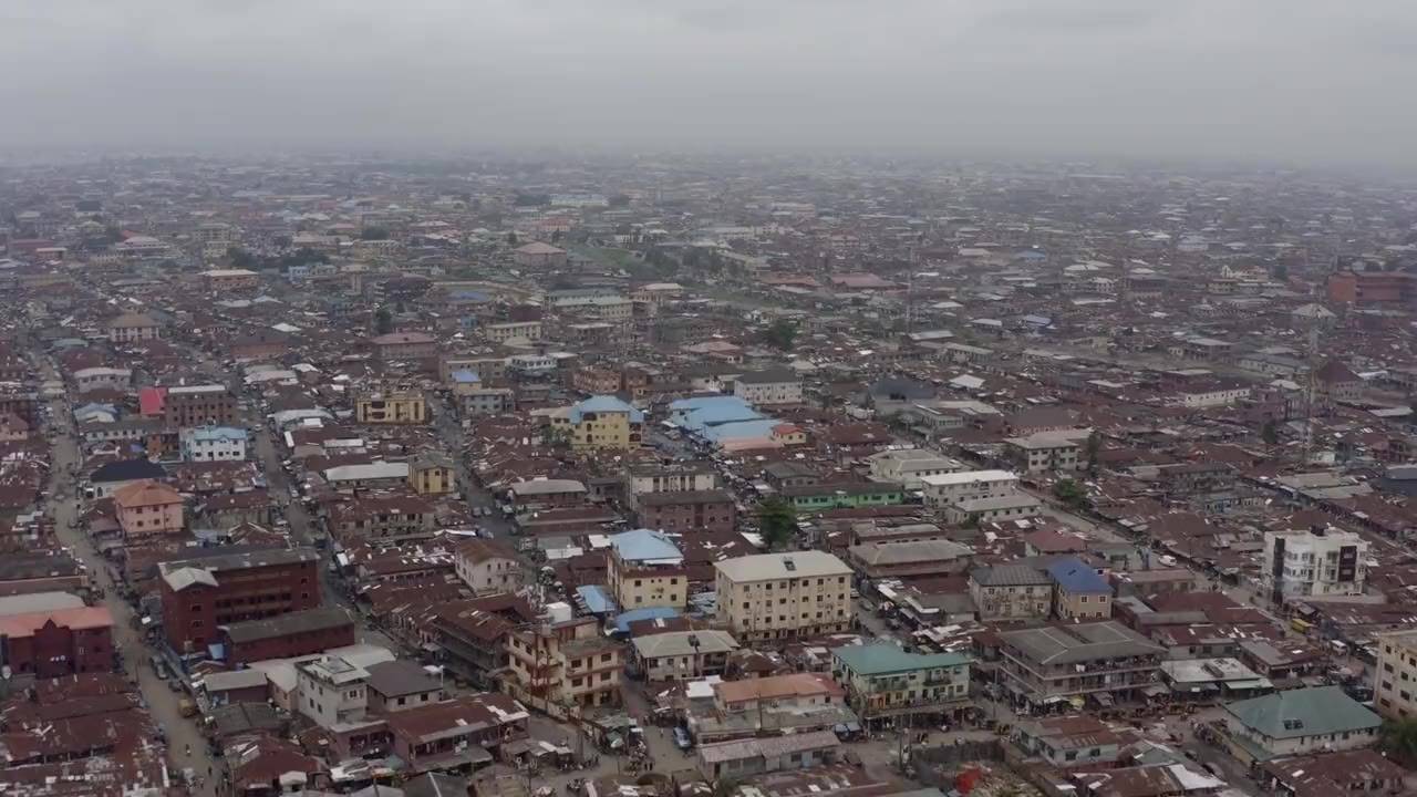 Ilobu from the air: dense rust-red rooftops running street after street into the haze.