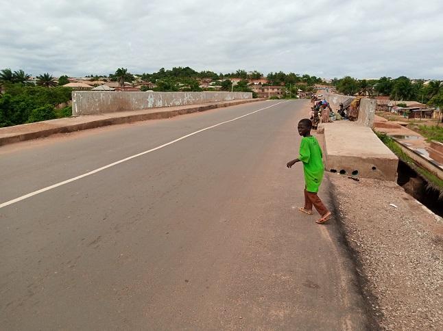 Ojutu bridge, a boy crossing on foot, the town beyond the parapet.
