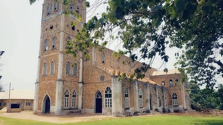 St Michael’s Anglican Church, built of laterite stone in 1909, its tower rising above the trees.